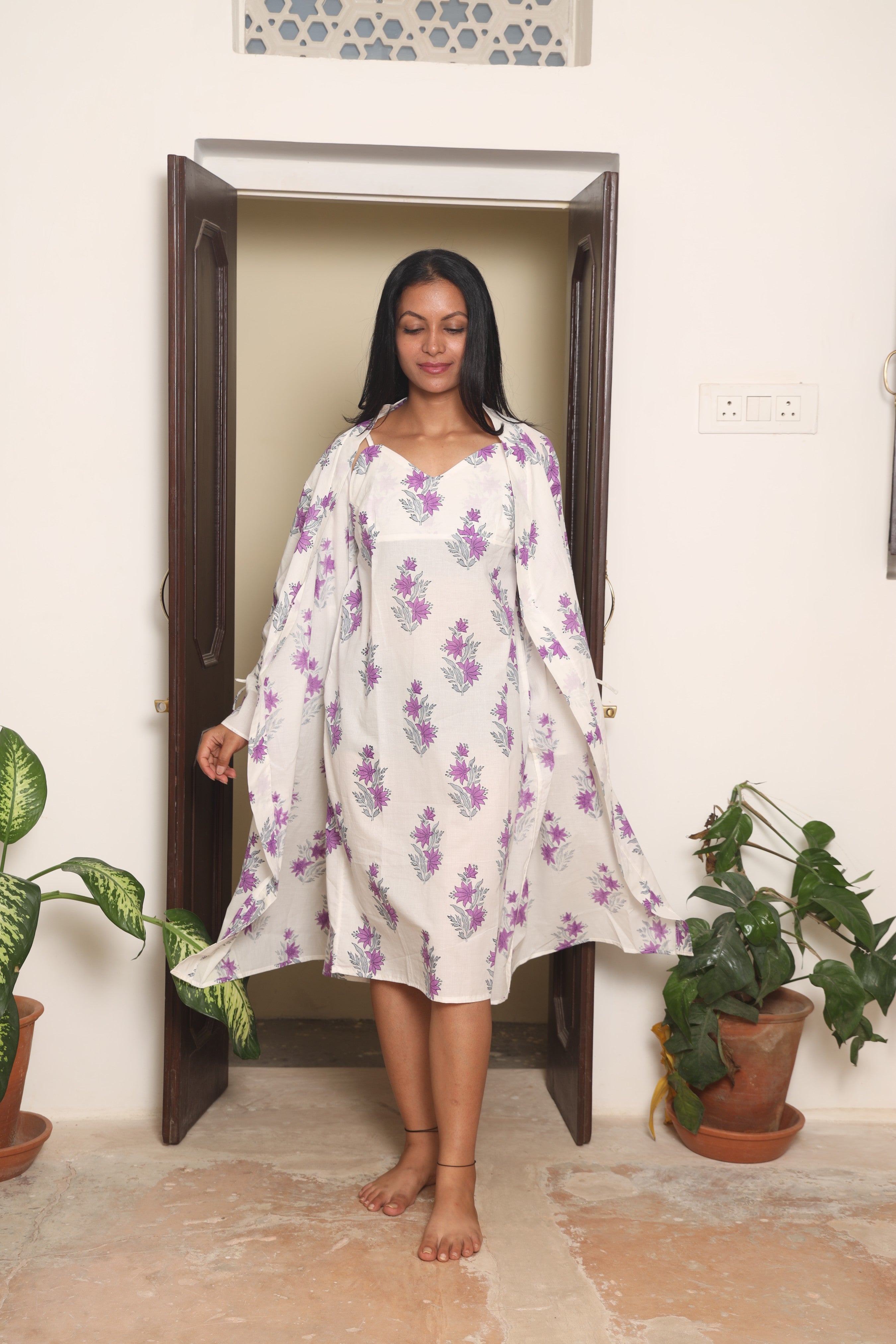Woman wearing lightweight cotton pajamas for summer nights in a relaxed bedroom
